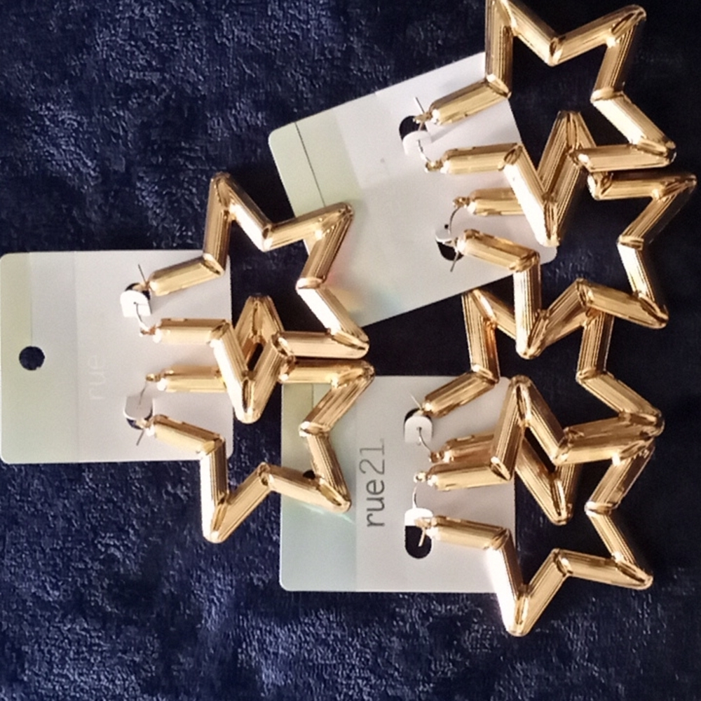 Large, gold tone star earrings. 3 pairs